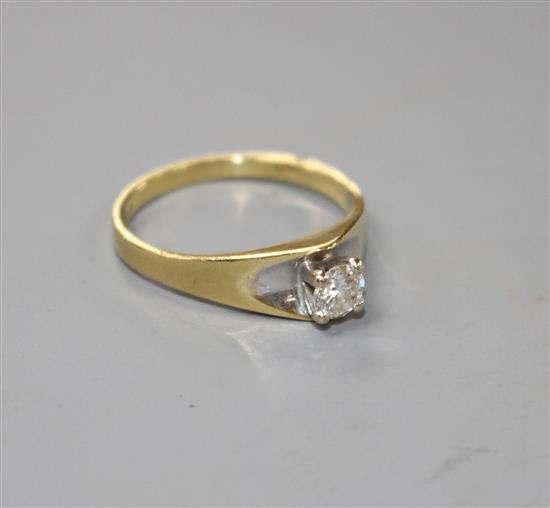 A modern 18ct gold and solitaire diamond ring,